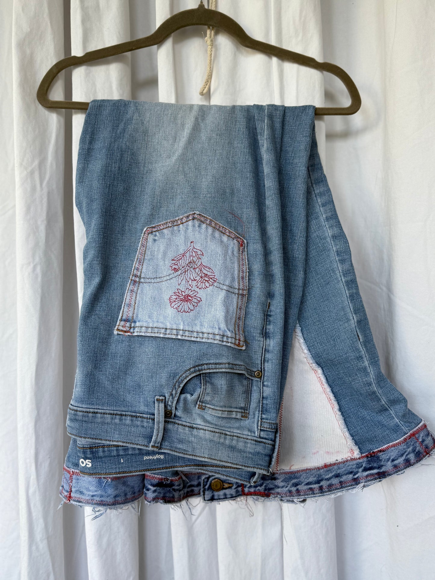 Light Wash Bell Bottom Jeans – Floral Embroidery & Raw Edge Details