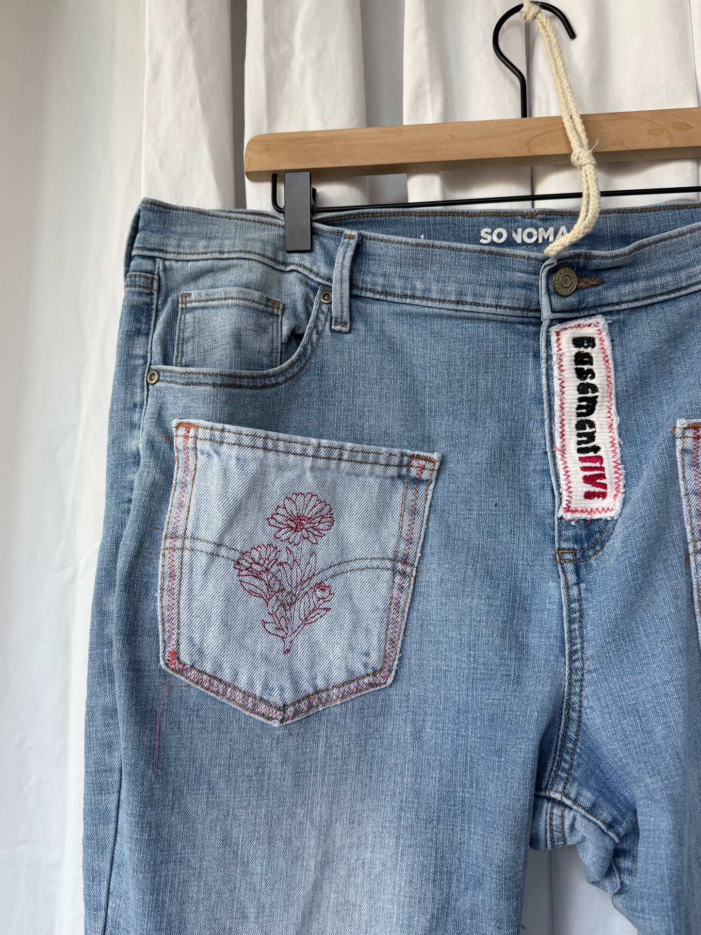 Light Wash Bell Bottom Jeans – Floral Embroidery & Raw Edge Details