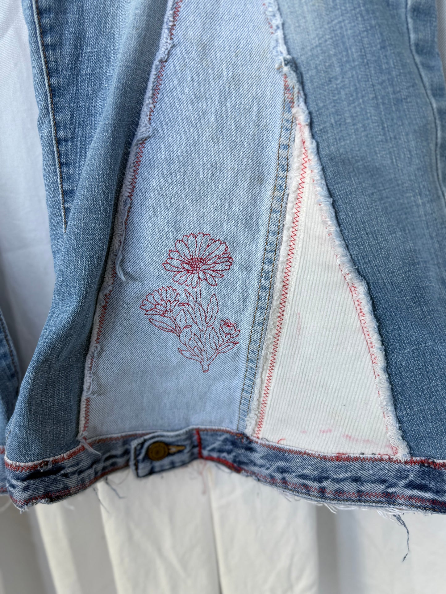 Light Wash Bell Bottom Jeans – Floral Embroidery & Raw Edge Details