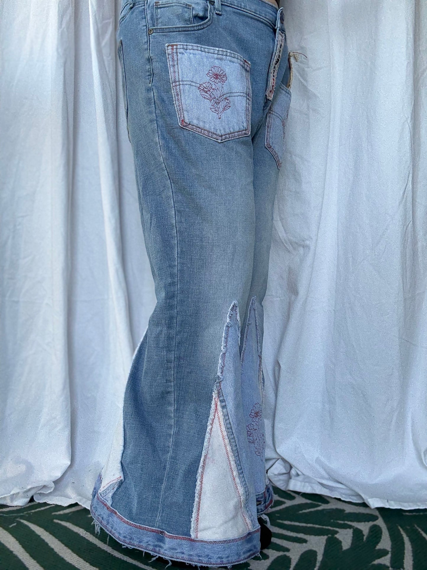 Light Wash Bell Bottom Jeans – Floral Embroidery & Raw Edge Details