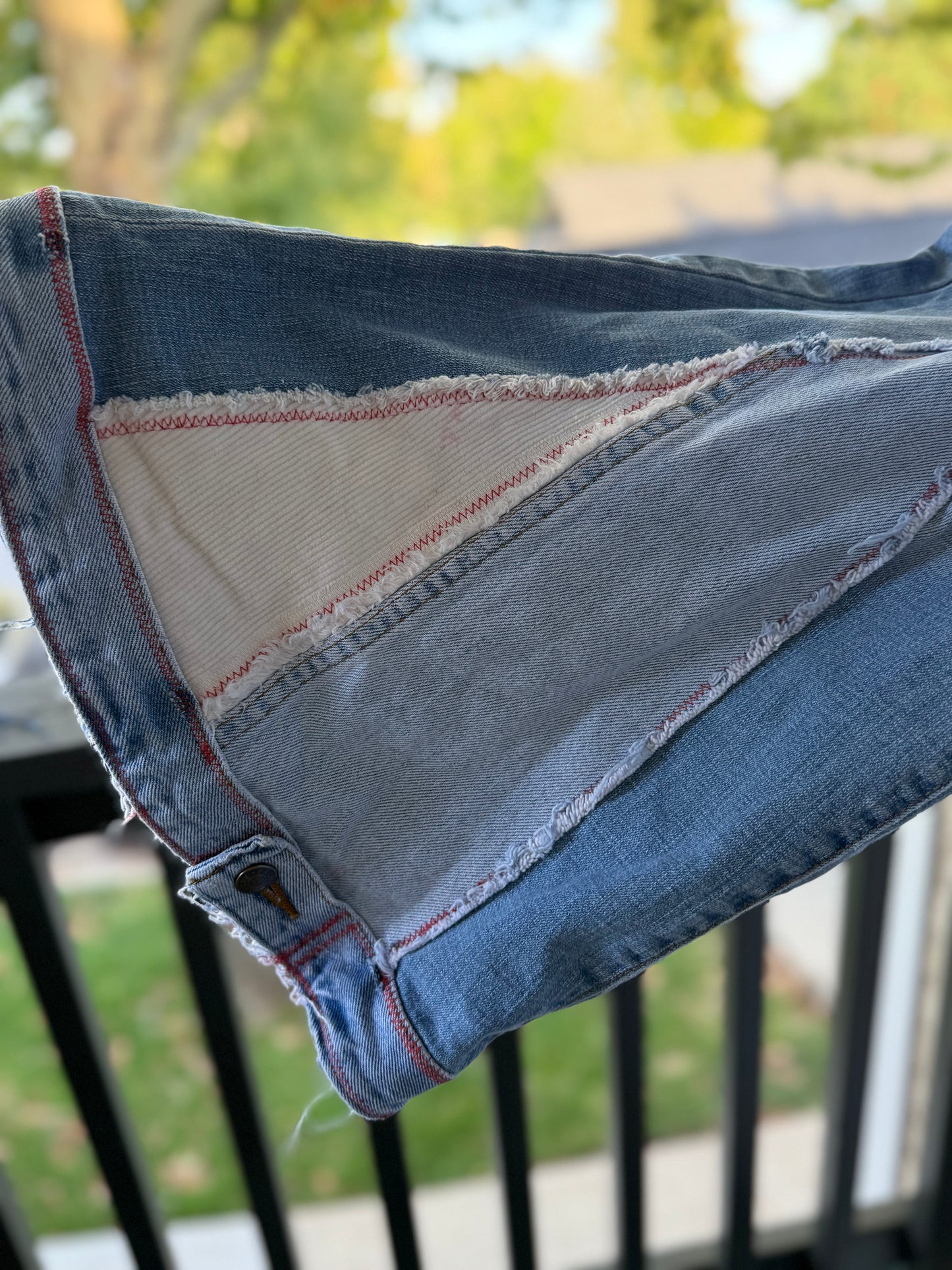 Light Wash Bell Bottom Jeans – Floral Embroidery & Raw Edge Details