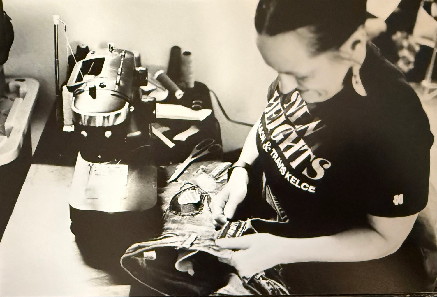 Person working in front of sewing machine.